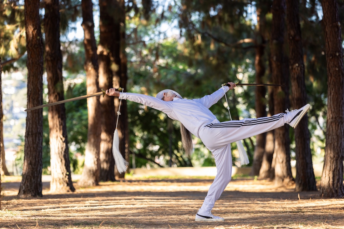 A person holding two spears
Description automatically generated