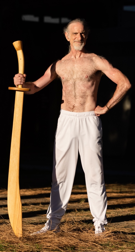 A person holding a sword
Description automatically generated